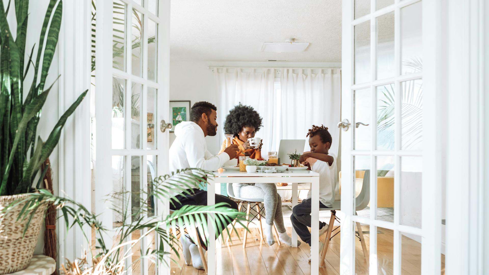 family of three sitting at a table for dining