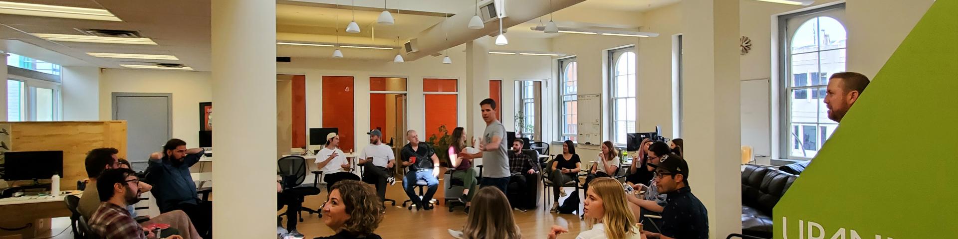 Upanup team members sit in circle in the room